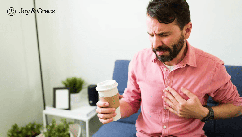 man sitting on sofa and holding up a coffee cup