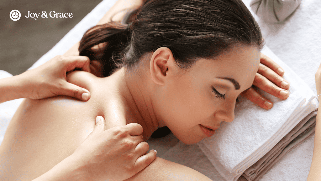 a woman getting a body massage with her hands on the back