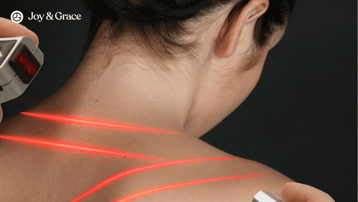 a woman with her arm in front of a red laser tattoo on her back