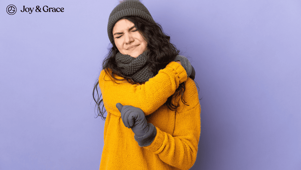 woman touching her shoulder pain in cold weather
