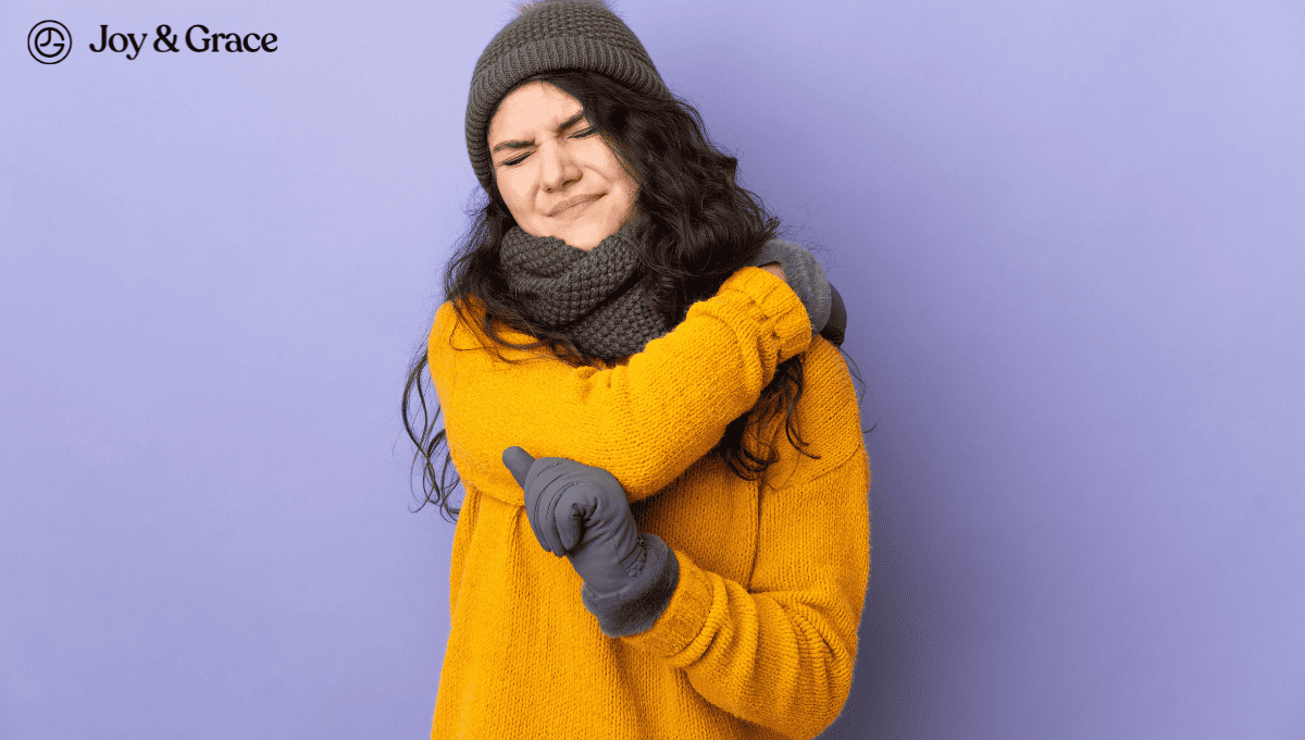 woman touching her shoulder pain in cold weather