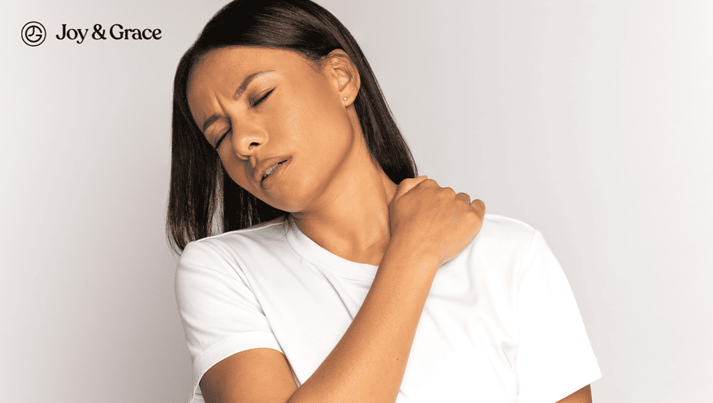 a woman with her hand over her shoulder and neck pain