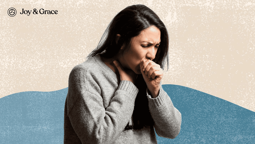 a woman in gray holding her hand to her mouth while coughing