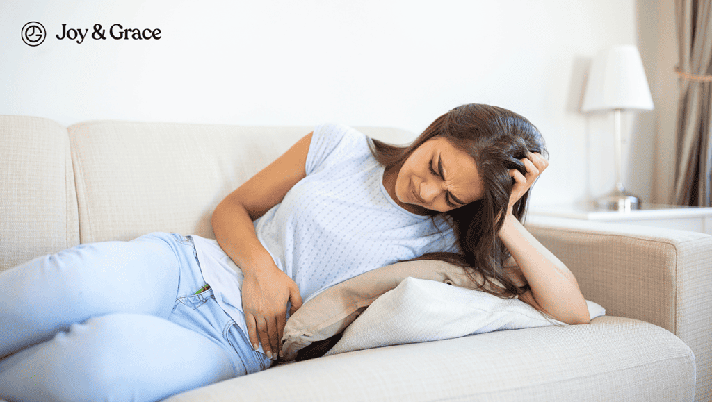 a woman resting her head on her arms while laying on a couch