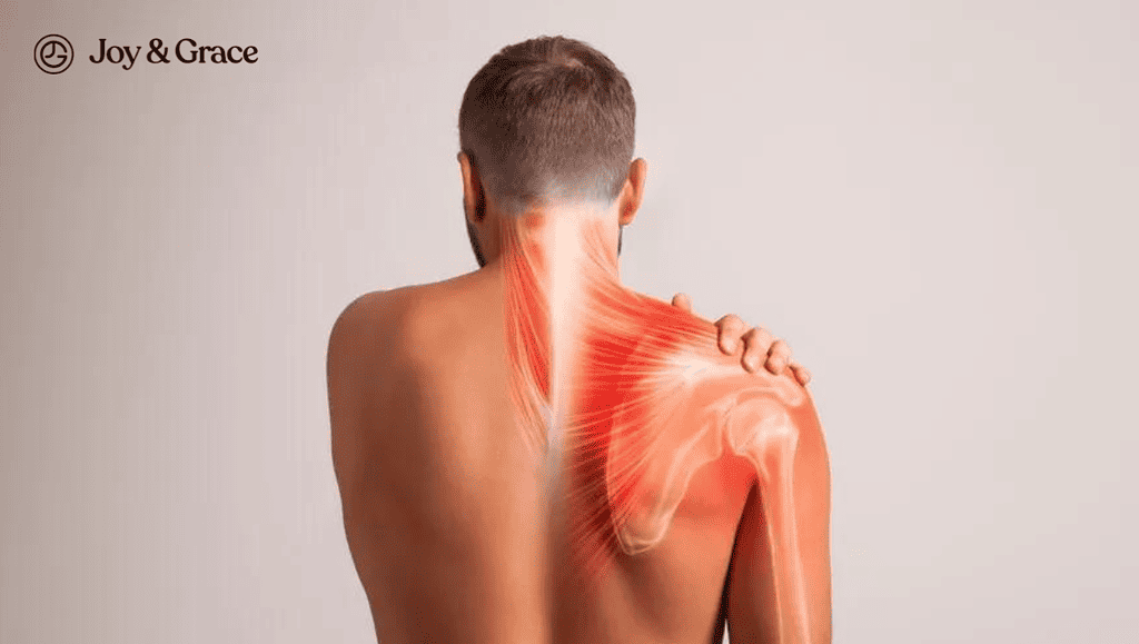 a young man is holding his neck and shoulder in pain