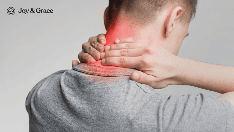 man has neck pain holding his hand to the neck