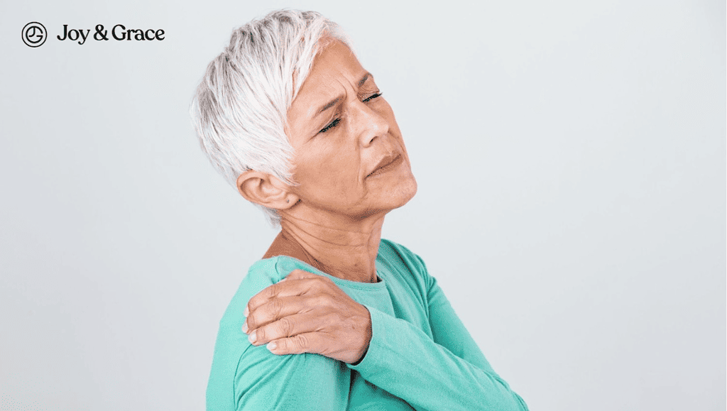 an old woman in pain while holding her shoulder