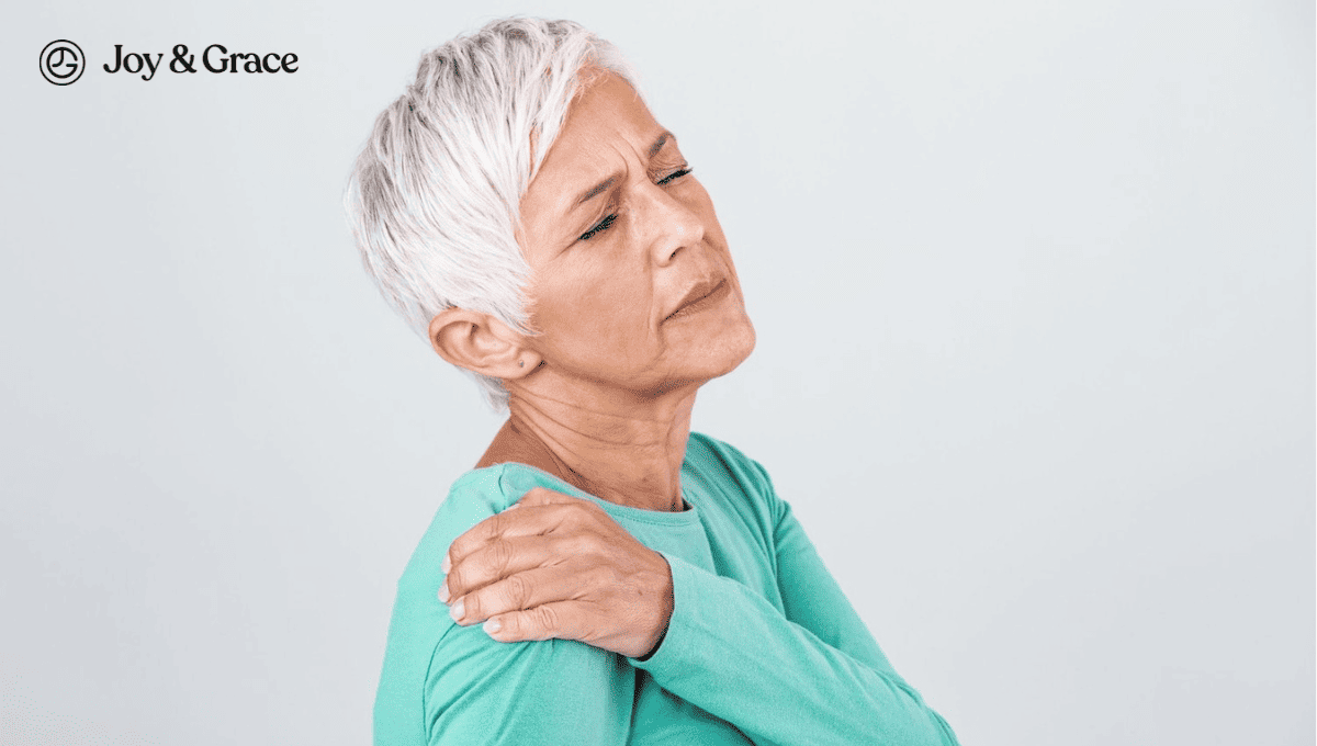 an old woman in pain while holding her shoulder