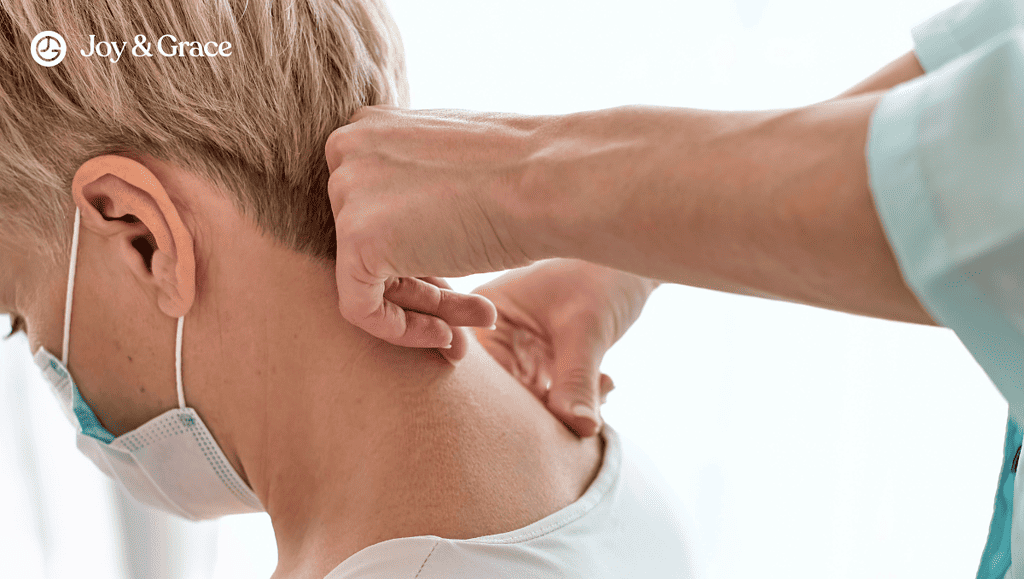 Medical provider testing a patient's neck