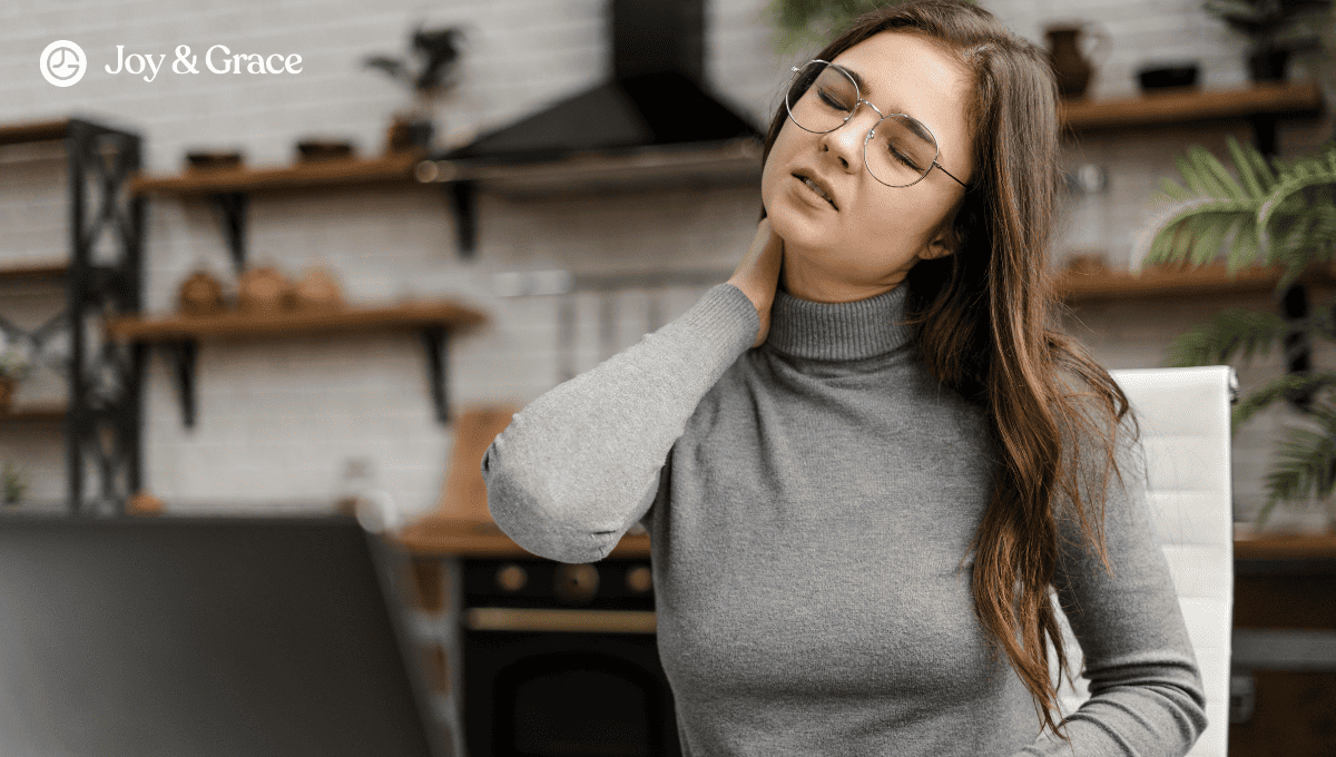 a woman looks exhausted as she works on her laptop