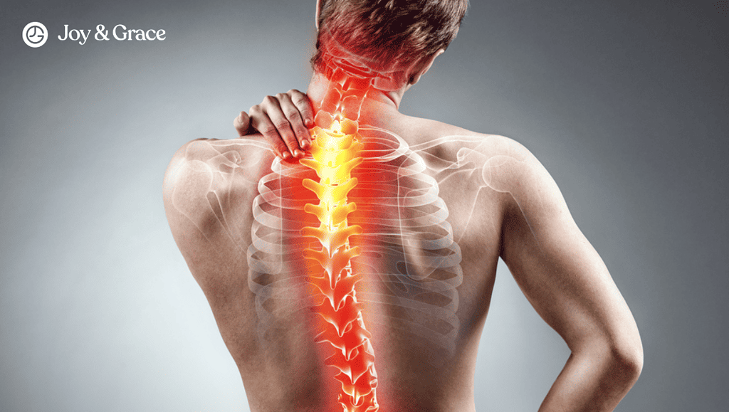 the back of a person holding their neck with bones in pain