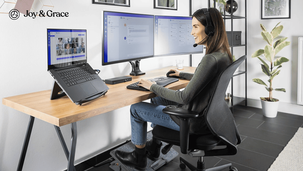 a smiling woman wearing headphones sitting at a computer desk