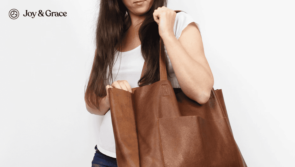 a woman is holding a brown bag in her hands