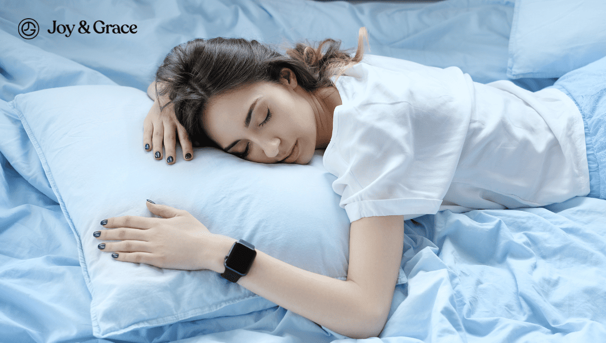 a young woman laying on a blue pillow in bed