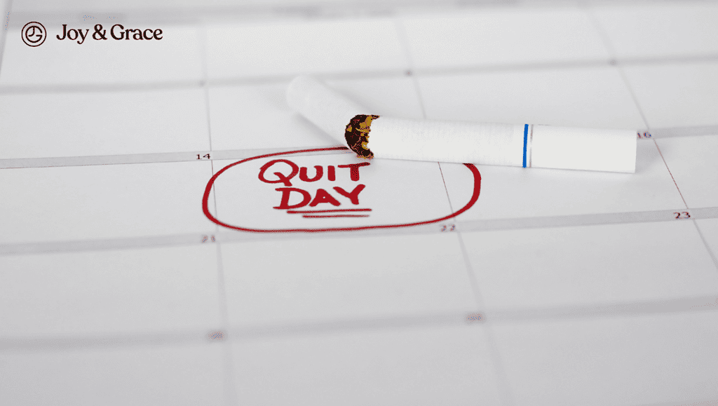 a white cigarette next to a calendar with quit day stamping