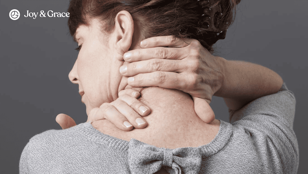 a woman with pain holding her back and neck up