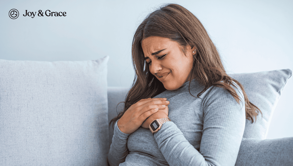 a woman sitting on a couch experiencing heart burn