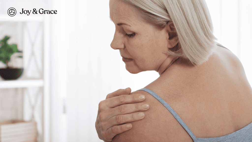 Woman holding her shoulder pain.