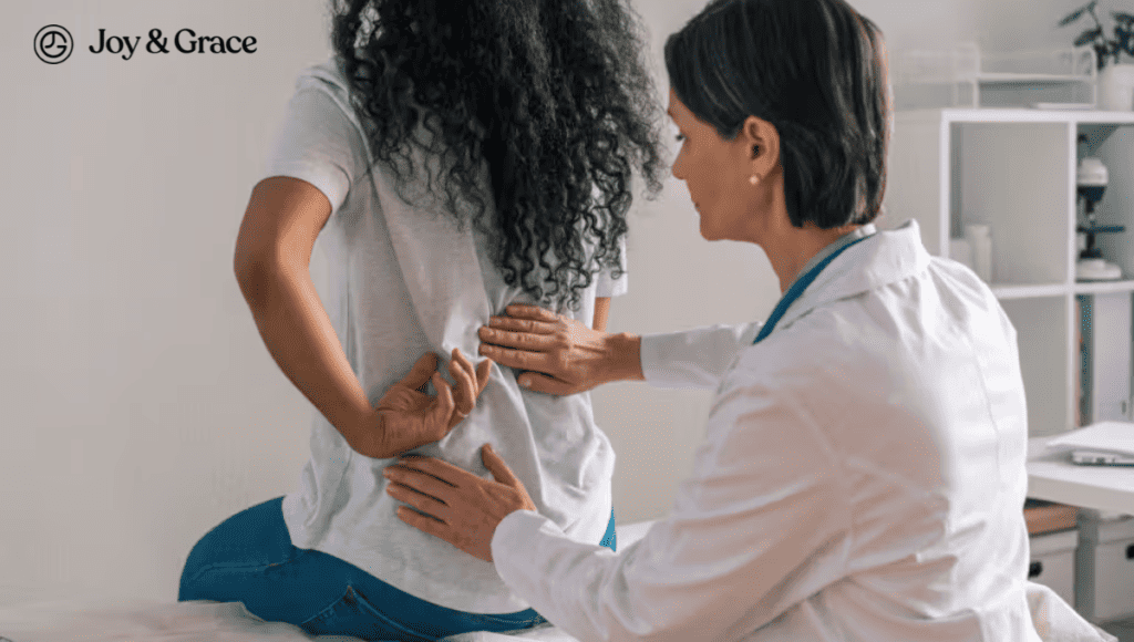 A woman is having her back examined by a doctor to evaluate her rib and shoulder pain.