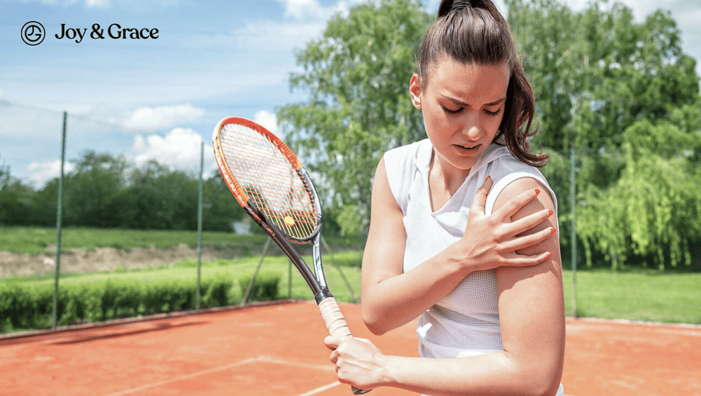 A woman experiencing rotator cuff pain while holding a tennis racket on a tennis court.