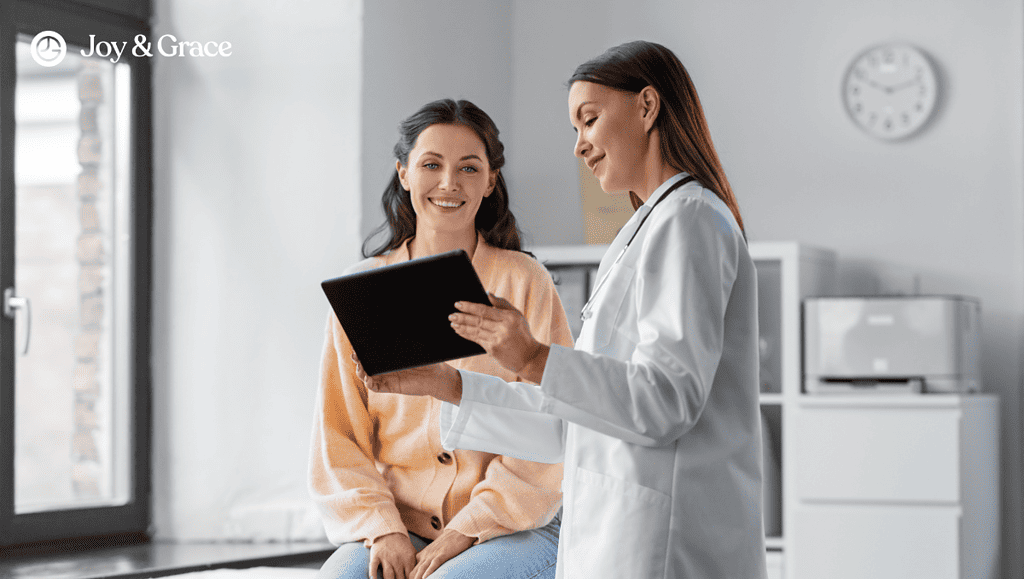 Two women discussing rotator cuff pain with a doctor through a tablet.