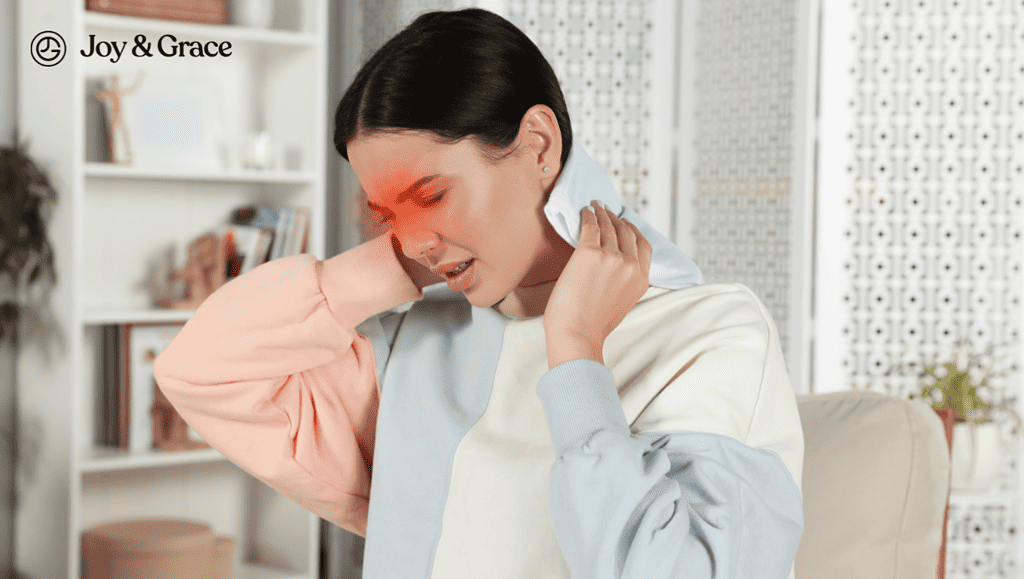A woman massaging her frontal sinuses with a heating pad in her neck