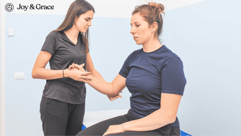 A woman is being examined by a physiotherapist to address sharp stabbing pains in her shoulder blade.