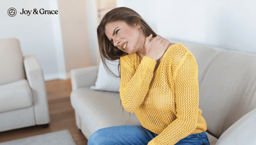 A woman is sitting on a couch with neck pain.