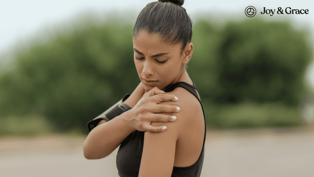 A woman with shoulder pain is holding her arm while walking