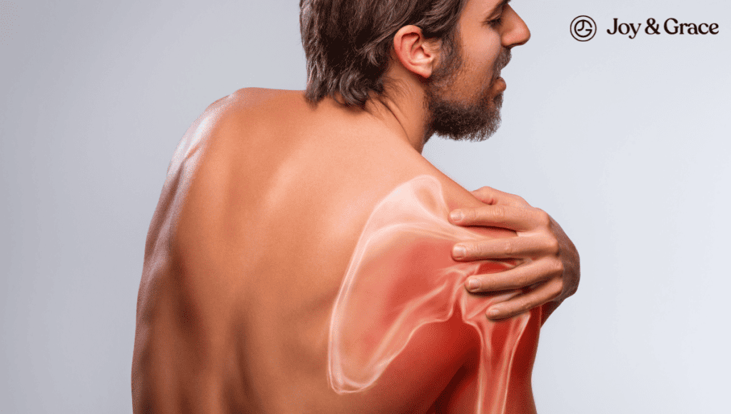 A man experiencing shoulder pain is holding his shoulder, seeking a guide to help alleviate sharp stabbing pains in his shoulder blade.