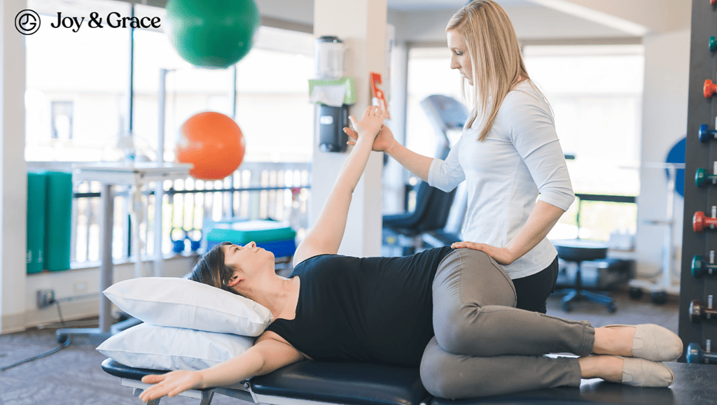 A woman with shoulder pain is being helped by a physical therapist.