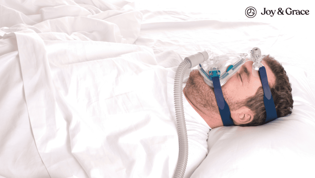 A man experiencing night neck pain, laying in bed with a mask on his face.