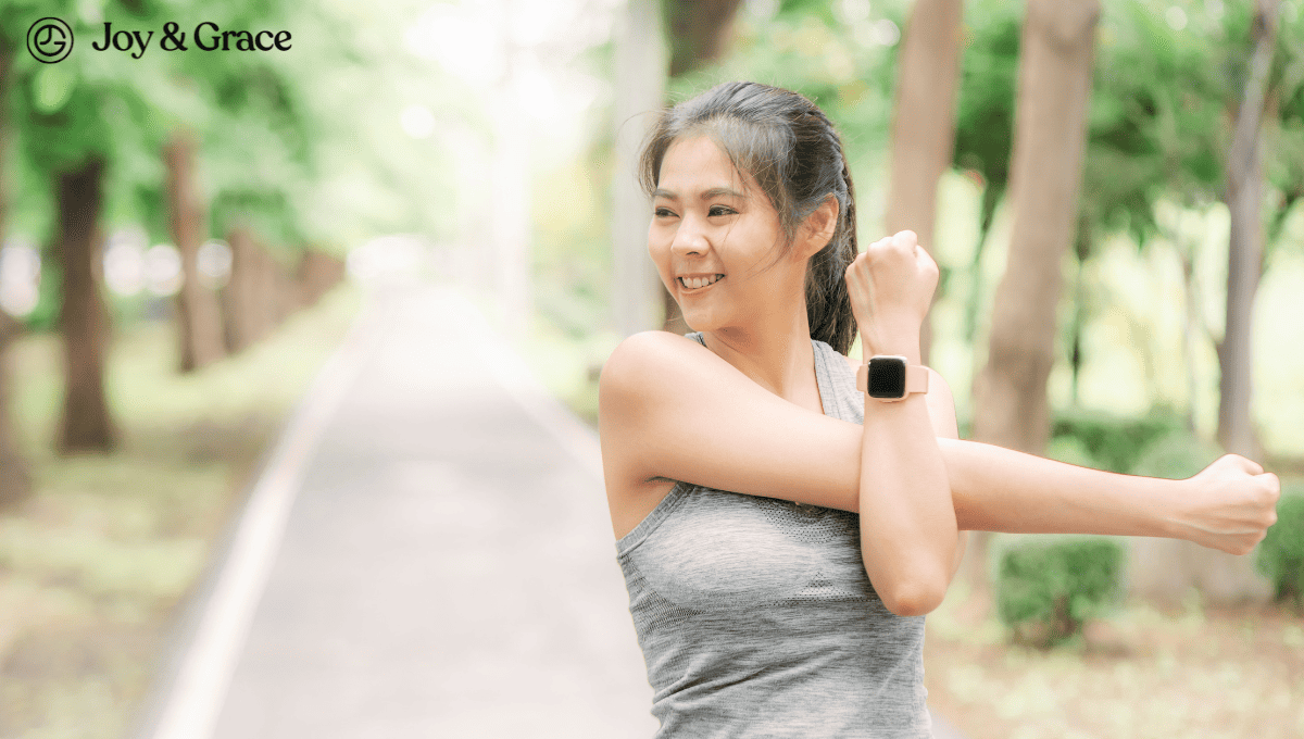 A woman wearing a smart watch demonstrating relief exercises for upper shoulder pain.