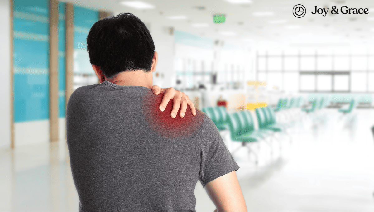 A man with shoulder pain is standing in the ER hallway.