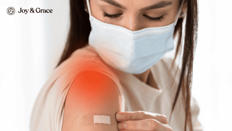 A woman wearing a medical mask with a bandage on her arm, possibly indicating post-flu shot discomfort.