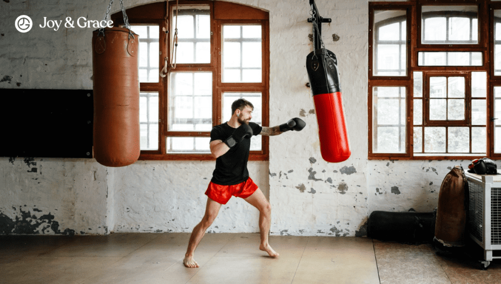 A man is vigorously punching a boxing bag at the gym.