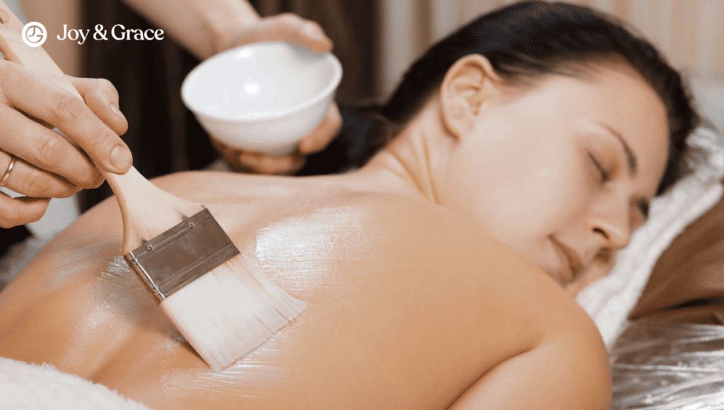 A woman receiving a soothing back massage for shoulder pain at a spa.