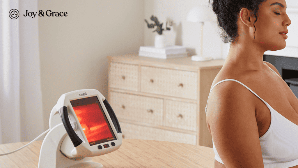 A woman is sitting in front of an ultrasound machine, undergoing heat therapy to relieve shoulder pain.