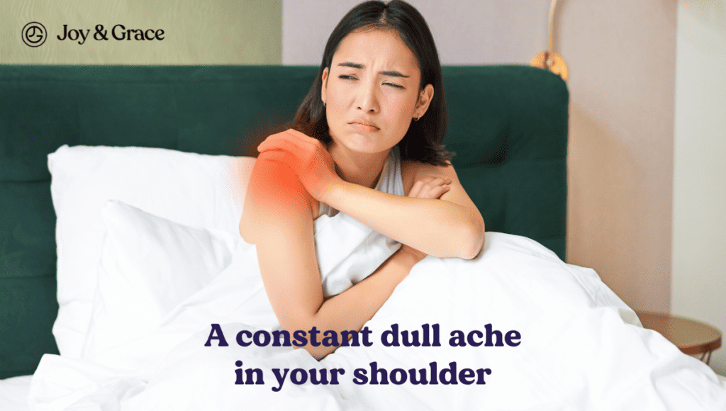 A woman laying in bed with the constant dullache in her shoulder, possibly caused by rheumatoid arthritis.