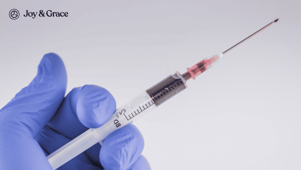 A person administering a Cortisone shot with a syringe and needle.