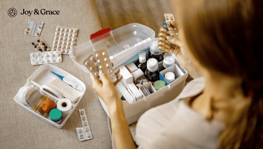 A woman is sitting on a couch with arm pain, holding medicine in a box.