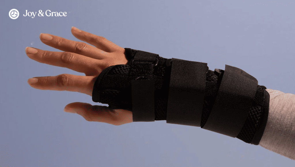 A person's hand with a wrist brace on it due to Carpal Tunnel Syndrome.